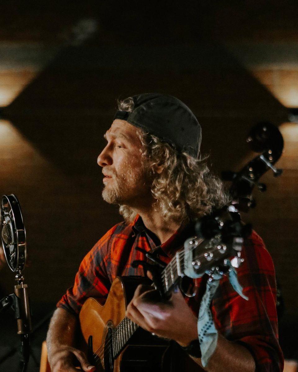 Trey Lindsley, known as TREYL, playing acoustic guitar